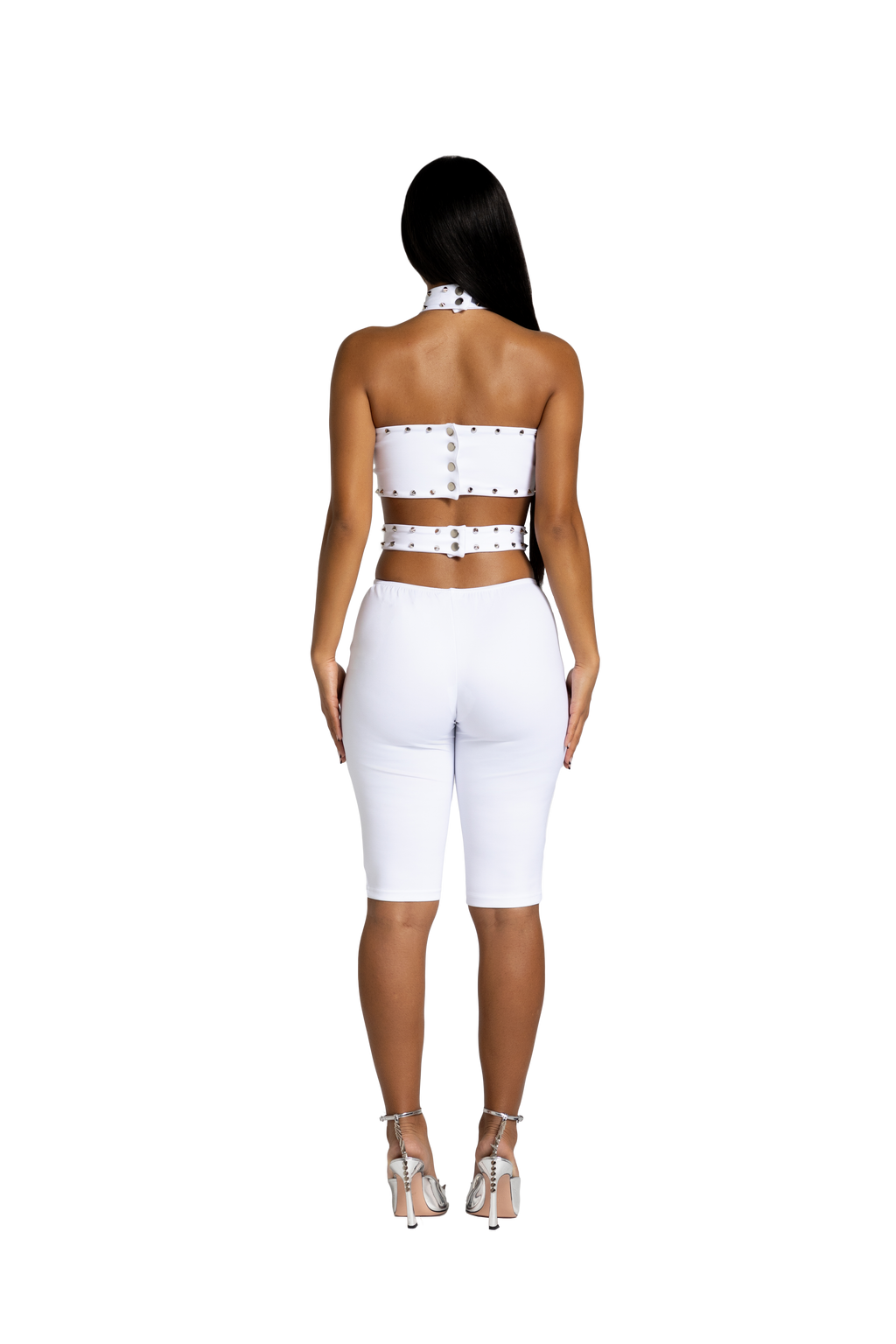 Back view of white studded cutout jumpsuit with fitted silhouette
