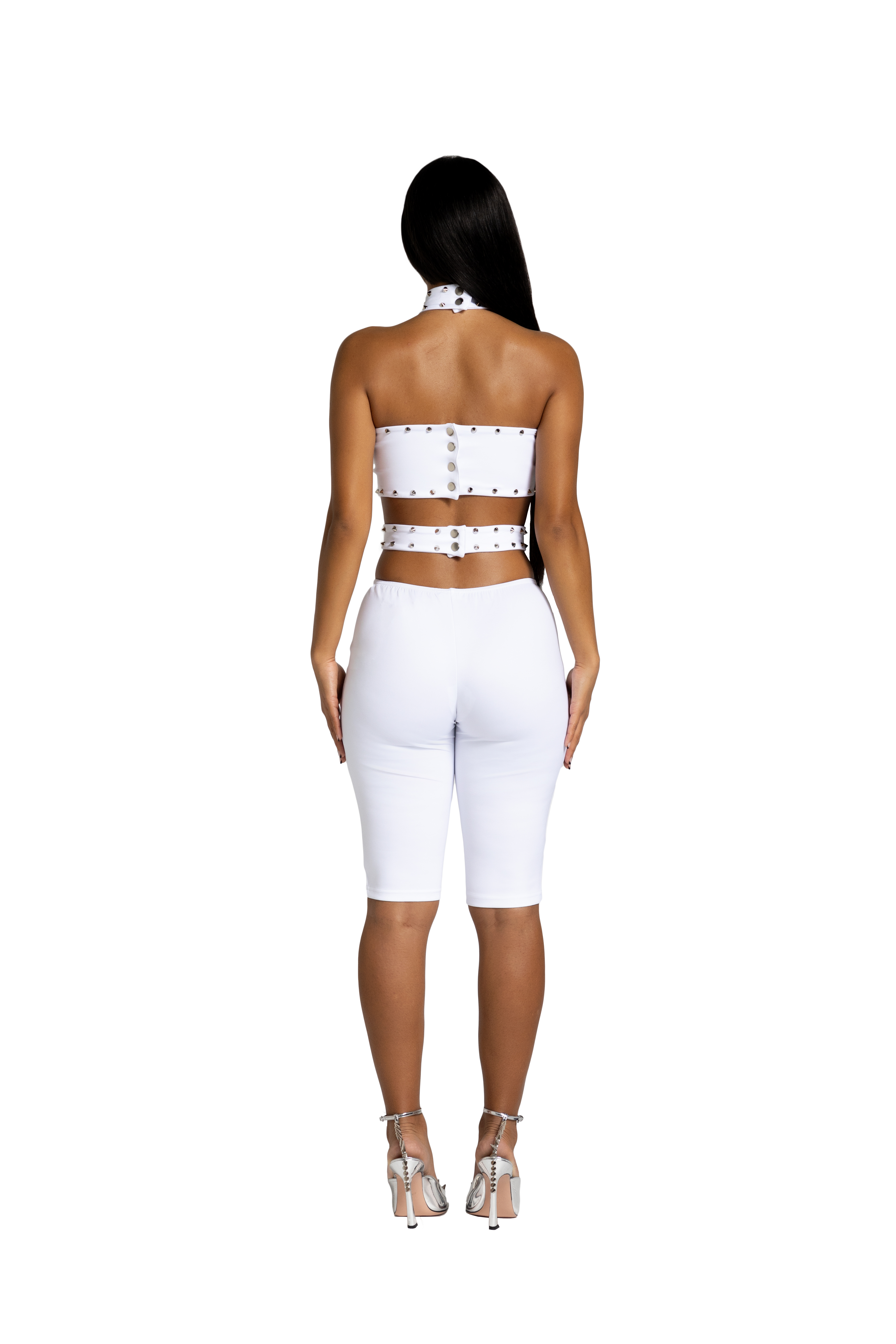 Back view of white studded cutout jumpsuit with fitted silhouette