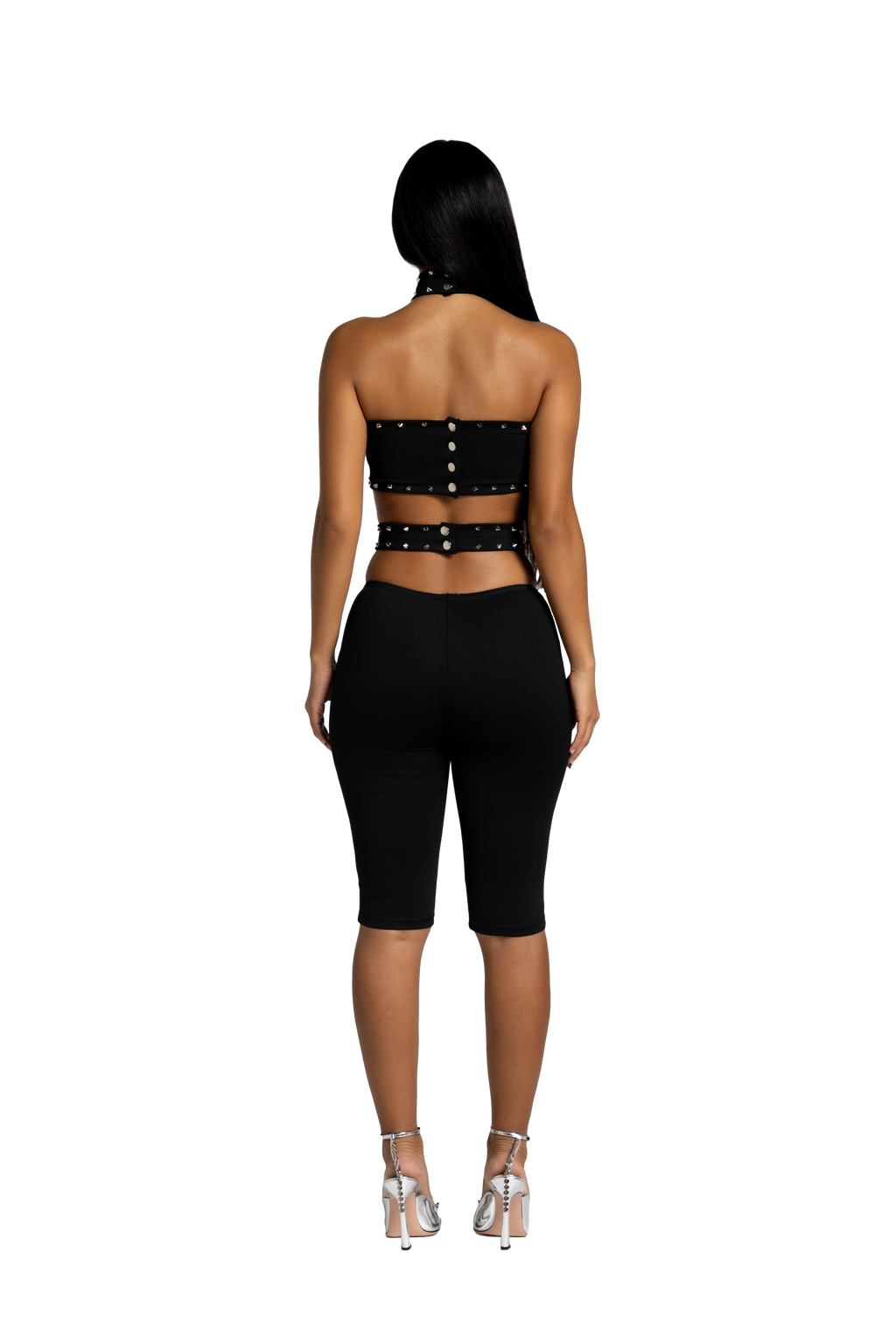 Back view of black studded open back short jumpsuit