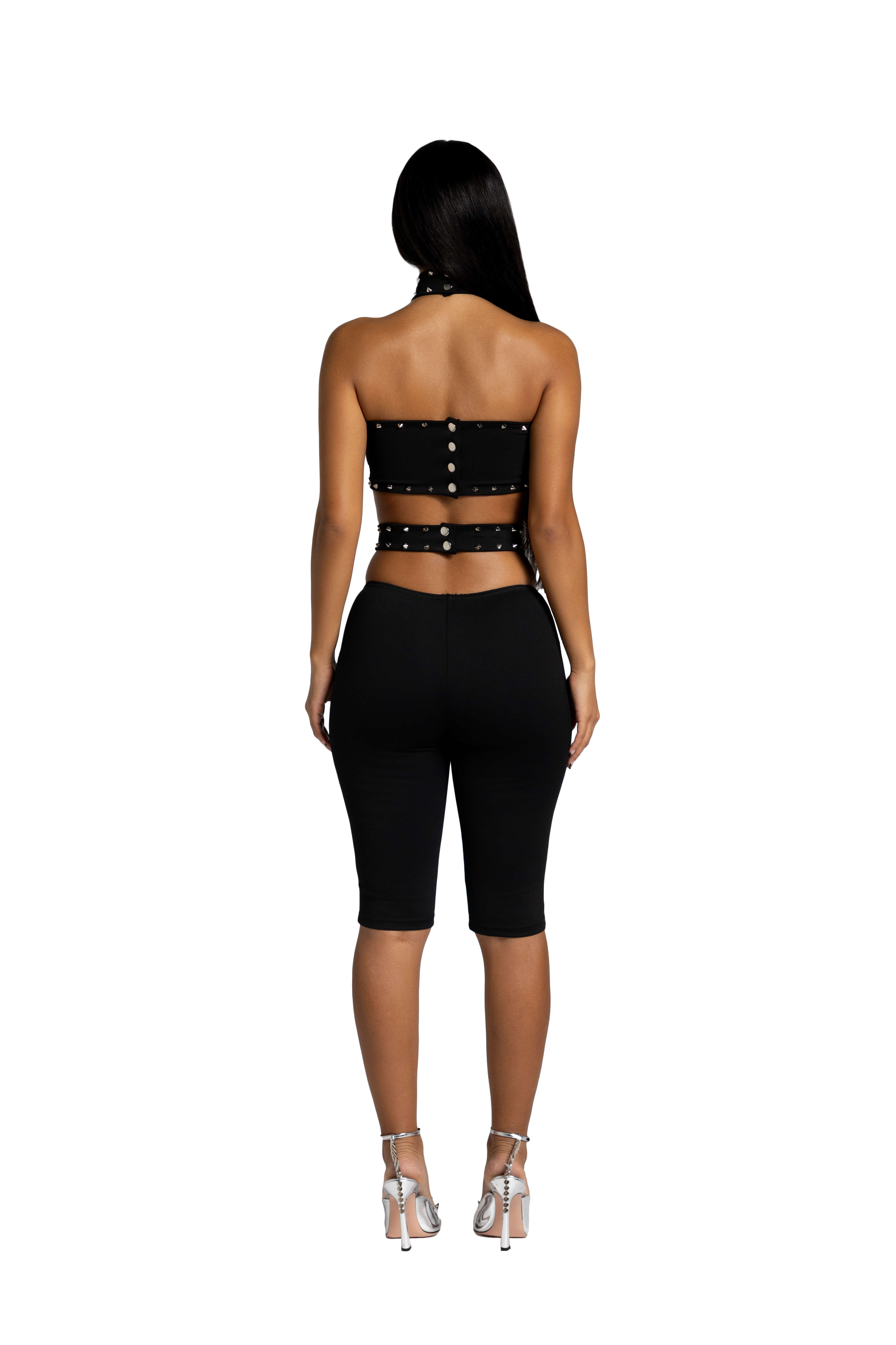 Back view of black studded open back short jumpsuit