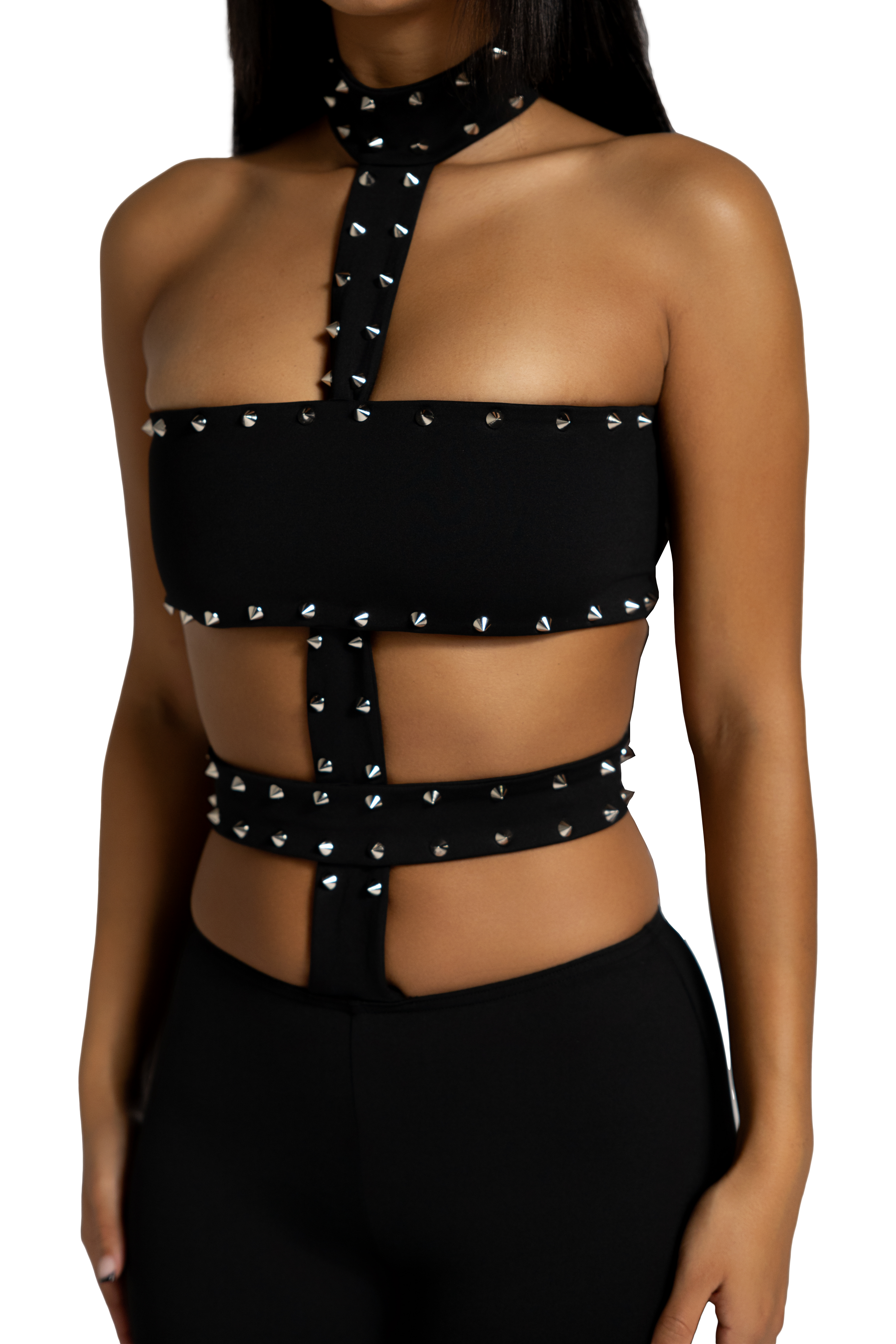 Side view of black studded cutout jumpsuit with fitted silhouette 